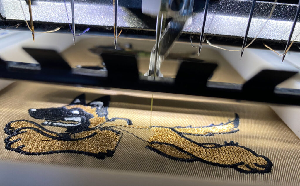 Belgian Malinois patch being embroidered for use on the field sweater